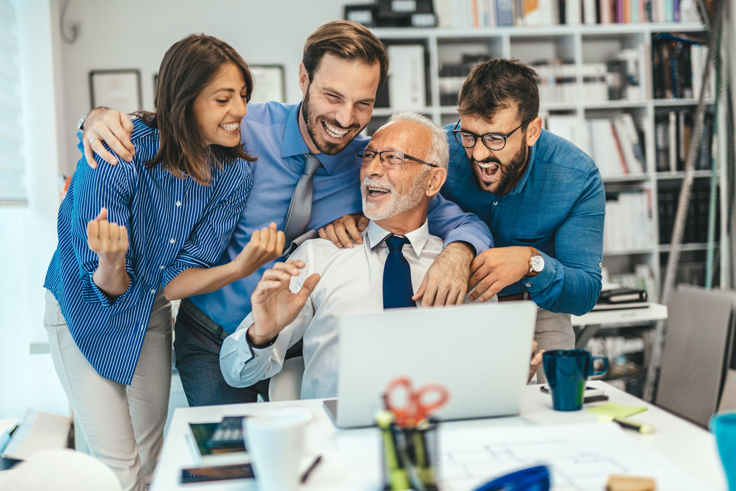 Group of people celebrating in the office
